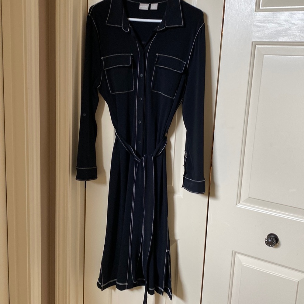 Black polyester below the knee dress with white stitching detail.  Button down.